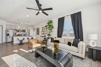 A modern living room with a black coffee table and a white sofa.